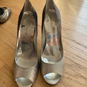 Snake skin silver open toe heels.